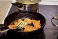 Frying chicken in a pan. Cooking potatoes Royalty Free Stock Photo