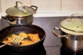 Frying chicken in a pan. Cooking potatoes Royalty Free Stock Photo