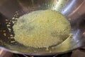 Frying chopped garlic in a wok.