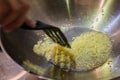 Frying chopped garlic in a wok.