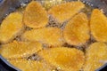 Frying classic breaded chicken pane cuisine in deep oil background, selective focus of chicken pane, tenders, fillet or goujons