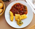 Frying cod in batter served with stewed vegetable ratatouille