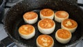 Frying cottage cheese fritters on a cooking pan Royalty Free Stock Photo