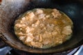 Frying crispy fried chicken meat with boiling oil in fry pan on gas stove Royalty Free Stock Photo