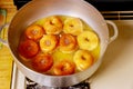 Frying donuts with hole in hot oil in deep pan