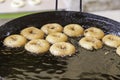 Frying donuts in a market