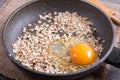 Frying egg with oatmeal in a frying pan. Healthy breakfast, healthy eating, vegan food concept. Royalty Free Stock Photo