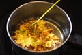 Frying elderflower in pancake batter in a small pot of boiling o