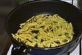 Frying French Fries in sunflower oil in a frying pan