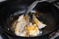 Frying fresh fish on a pan at home