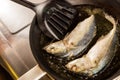 Frying fresh Mackerels in a pan