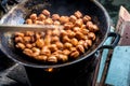 Frying meatballs in old pan on firewood stoves Royalty Free Stock Photo