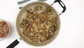 Frying mushrooms and onion on frying pan, close up Royalty Free Stock Photo