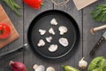 Frying the mushrooms in the pan. Traditional wooden kitchen table with knife Royalty Free Stock Photo