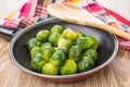 Frying pan with brussels sprouts, wooden spoon and napkin Royalty Free Stock Photo