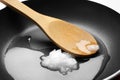 Frying pan with coconut oil and wooden spoon. Healthy cooking Royalty Free Stock Photo