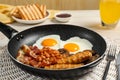 Frying pan with cooked traditional English breakfast on white table, closeup Royalty Free Stock Photo