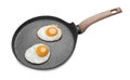 Frying pan with delicious fried eggs isolated on white Royalty Free Stock Photo