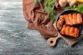 Frying pan with delicious ribs on wooden table