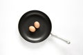 Frying pan and eggs on white background Royalty Free Stock Photo