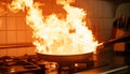 Frying pan with flames leaping from it in a dramatic kitchen accident showcasing fire hazard Royalty Free Stock Photo