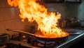 Frying pan with flames leaping from it in a dramatic kitchen accident showcasing fire hazard Royalty Free Stock Photo
