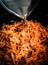 Frying pan with fried carrots. Water flowing. Toned