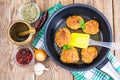 Frying pan with fried cutlets on wooden table Royalty Free Stock Photo