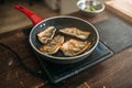 Frying pan with fried fish fillet, seafood cooking Royalty Free Stock Photo