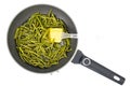 Frying pan with fried garlic arrows. Photo