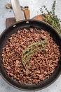 Frying Pan with fried mince beef meat, fresh cooked forcemeat. grey background. top view Royalty Free Stock Photo