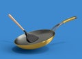Frying pan with glass lid and silicon solid turner on blue background.