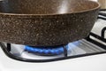 frying pan is heated on gas stove