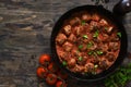 Frying pan with meat balls with tomato sauce on a wooden background Royalty Free Stock Photo