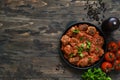 Frying pan with meat balls with tomato sauce on a wooden background Royalty Free Stock Photo