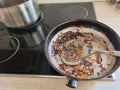 Frying pan with the remains of burnt scrambled eggs Royalty Free Stock Photo