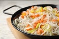 Frying pan with rice noodles, shrimps and vegetables