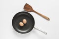 Frying pan and spatula and eggs on white background Royalty Free Stock Photo