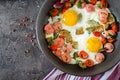 Frying pan with tasty cooked egg, sausages and vegetables on grey table Royalty Free Stock Photo