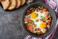 Frying pan with tasty cooked egg, sausages and vegetables on grey table Royalty Free Stock Photo