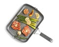 Frying pan with tasty grilled salmon, lemon and asparagus on white background, top view Royalty Free Stock Photo