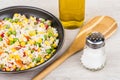 Frying pan with vegetable mix, bamboo spoon, vegetable oil Royalty Free Stock Photo