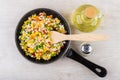 Frying pan with vegetable mix, oil and salt on table Royalty Free Stock Photo