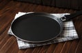 Frying pan on a wooden background Royalty Free Stock Photo