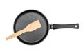 Frying pan with wooden spade on white background. Top view Royalty Free Stock Photo