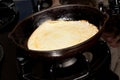 Frying pancake mix into pan Royalty Free Stock Photo