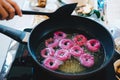 Frying purple sweet potato doughnut. deep fried dessert Royalty Free Stock Photo