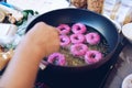 Frying purple sweet potato doughnut. deep fried dessert Royalty Free Stock Photo