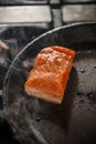 Frying salmon in black pan