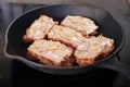 Frying scrapple slices on a cast iron pan Royalty Free Stock Photo